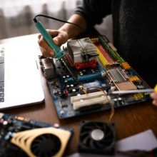 Close up of a woman hands repairing computer